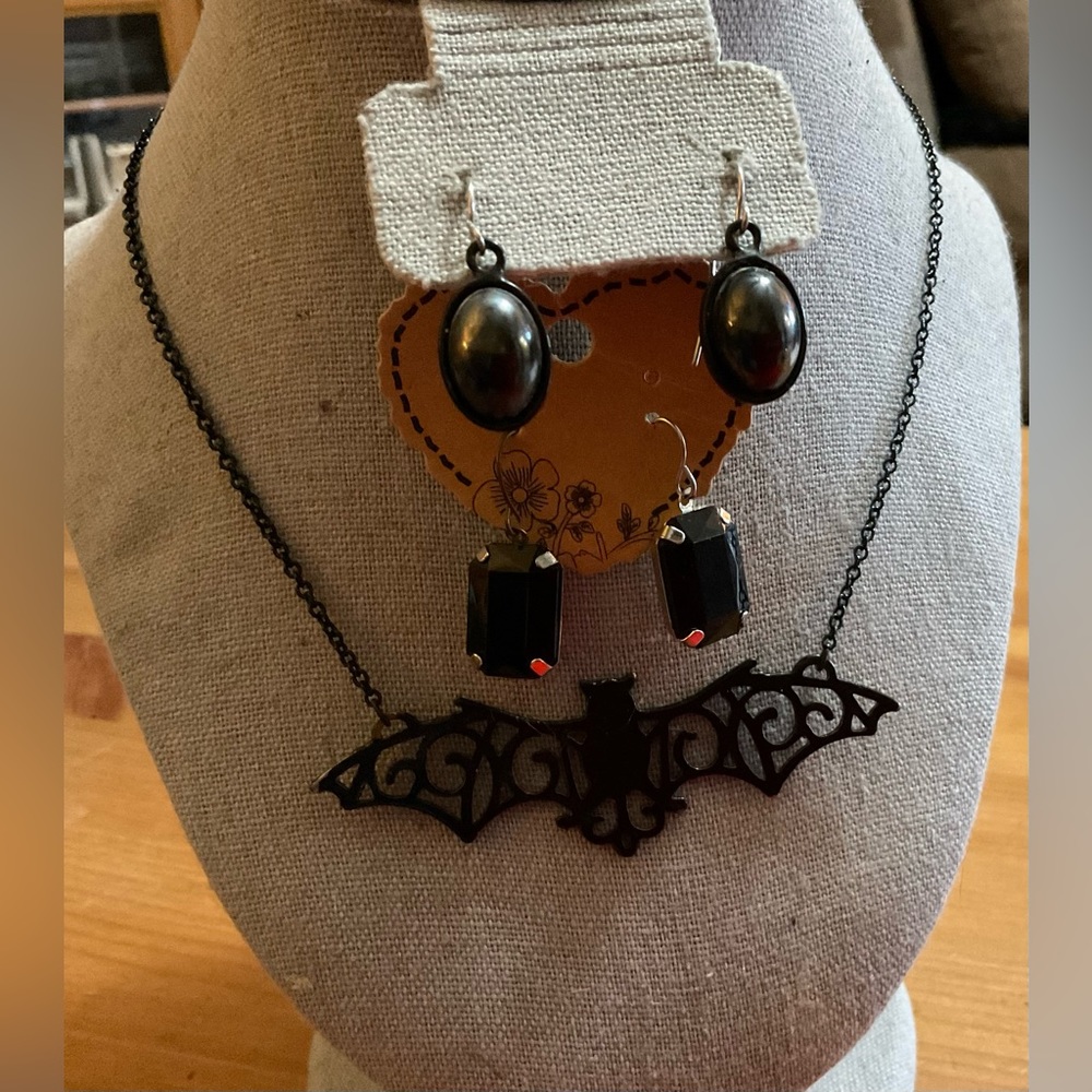 Gothic: metal bat necklace and two sets of dangle earrings biker core style too.